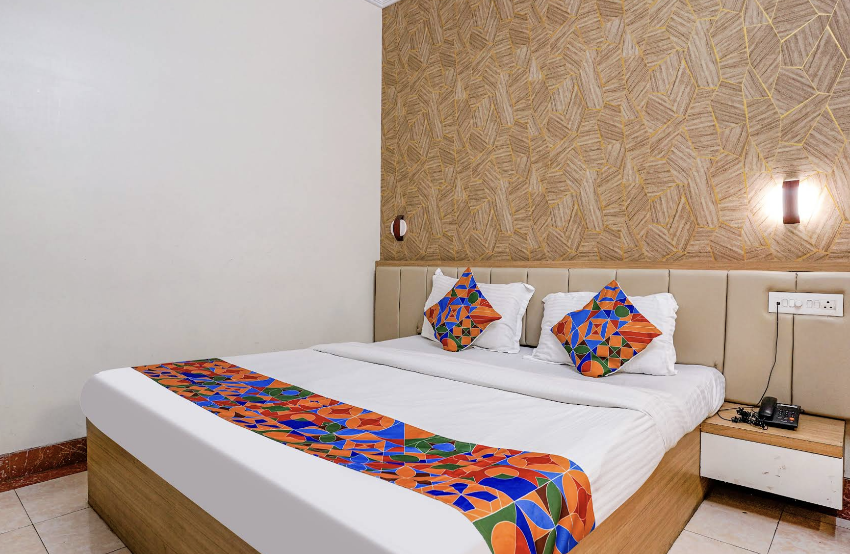 Hotel room bed with patterned accent wall